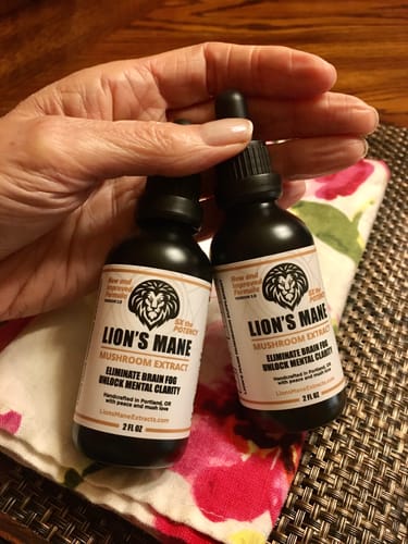 Verified customer with two bottles of Lion's Mane Extract